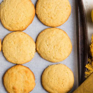 Baking sheet of lemon almond flour cookies fresh out of the oven, ready to eat.