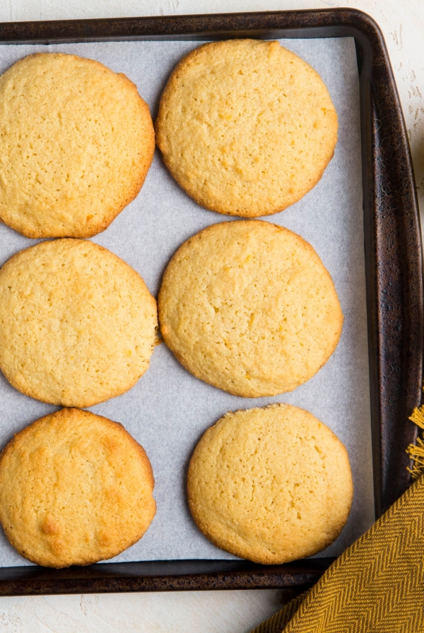 Baking sheet of lemon almond flour cookies fresh out of the oven, ready to eat.