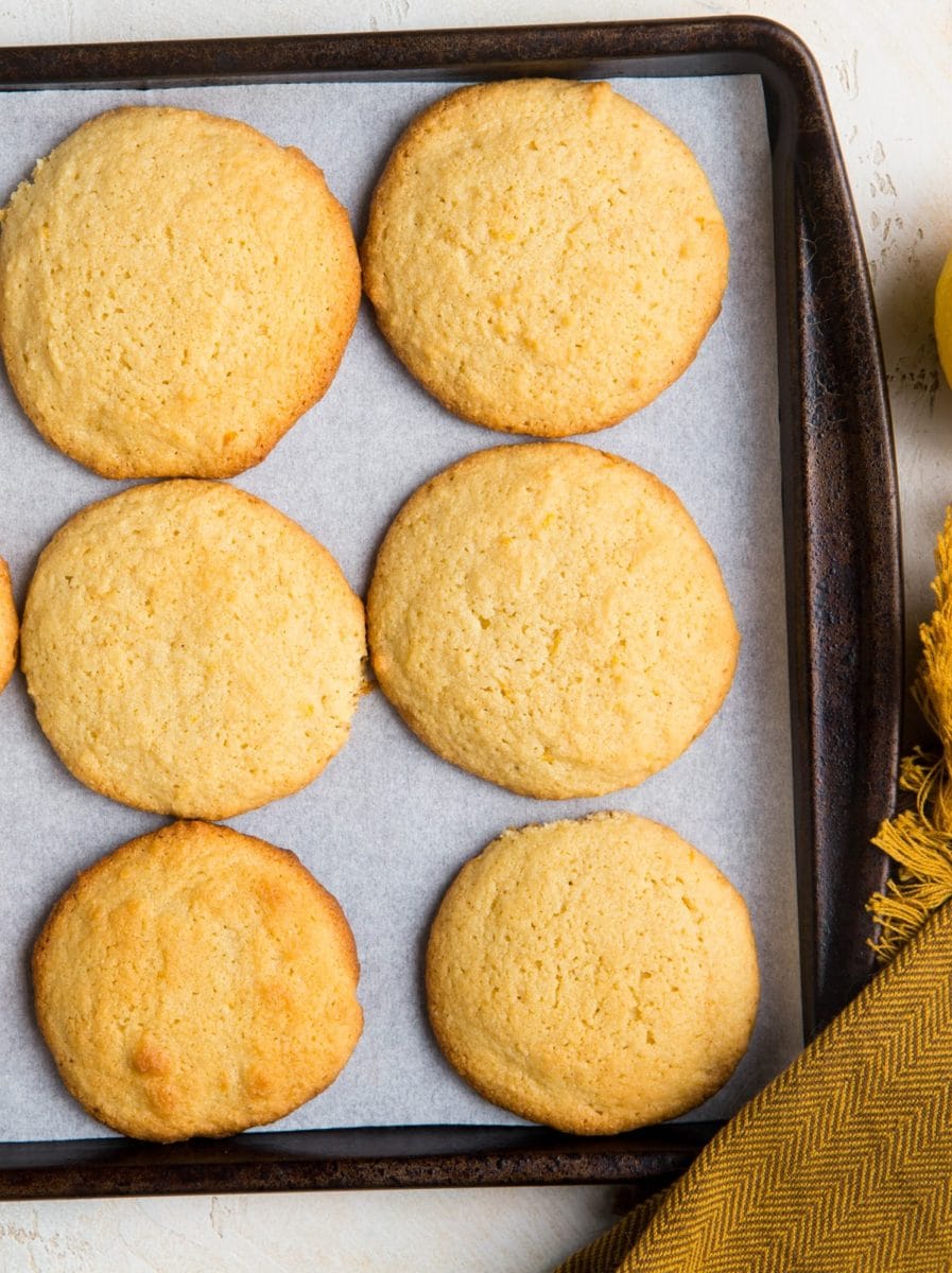 Baking sheet of lemon almond flour cookies fresh out of the oven, ready to eat.