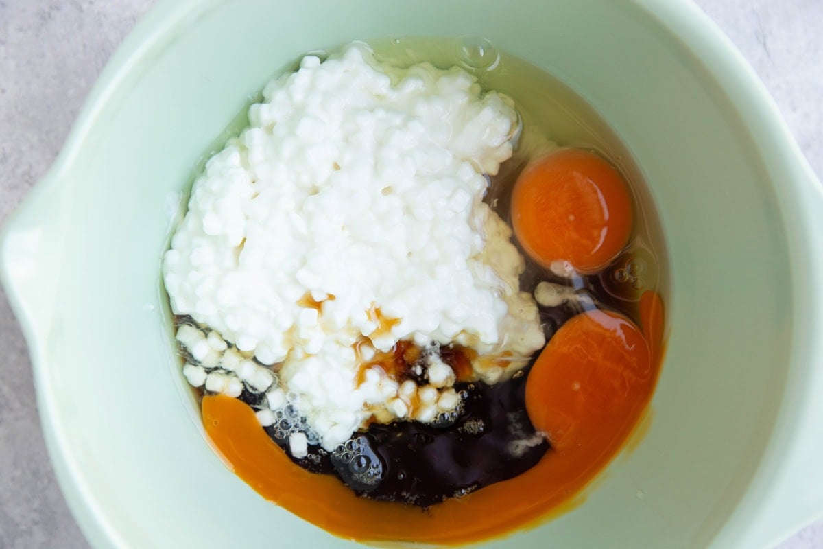 Mixing bowl full of wet ingredients to make cottage cheese bread.