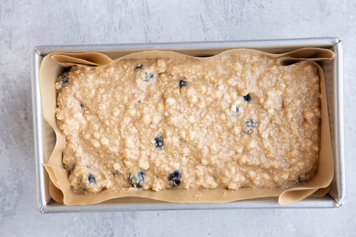 Loaf pan with cottage cheese bread batter inside, ready to go into the oven.