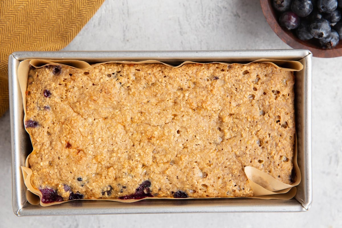 Blueberry cottage cheese bread in a loaf pan, fresh out of the oven.
