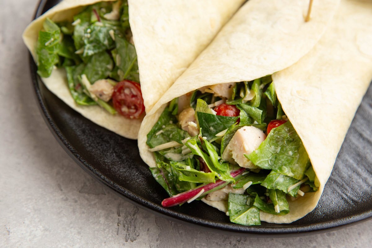 Plate of two salad wraps.