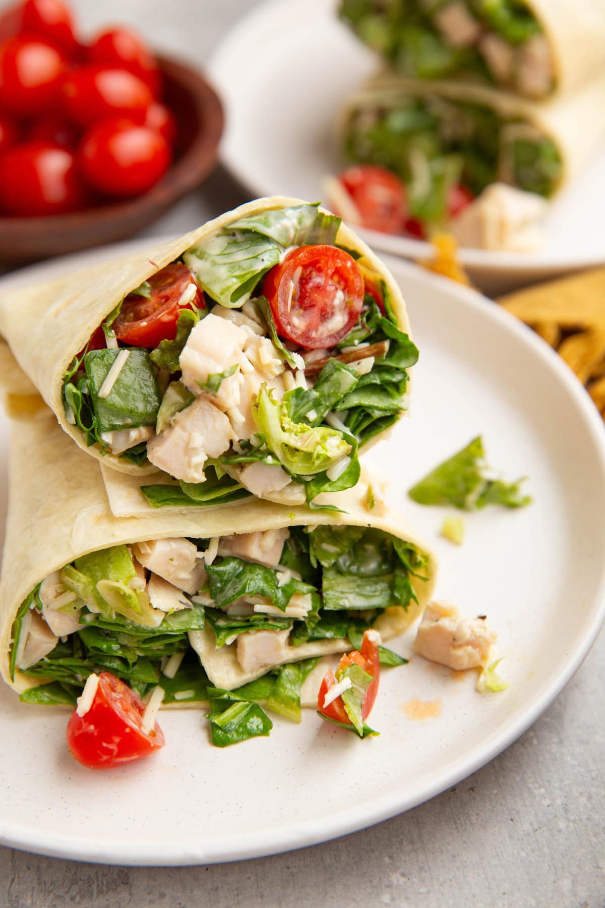 Plate with Chicken wraps stacked on top of each other, ready to eat.