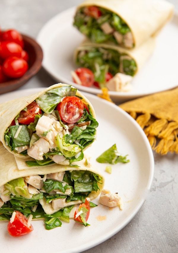 Chicken Caesar wraps on plates, ready to eat.