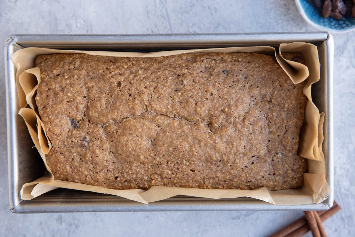 Loaf pan of raisin bread fresh out of the oven.