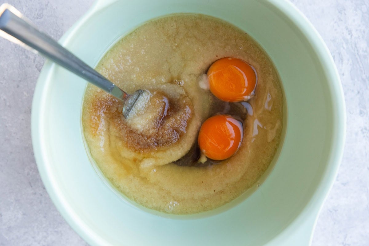 Wet ingredients for oatmeal raisin bread in a mixing bowl.