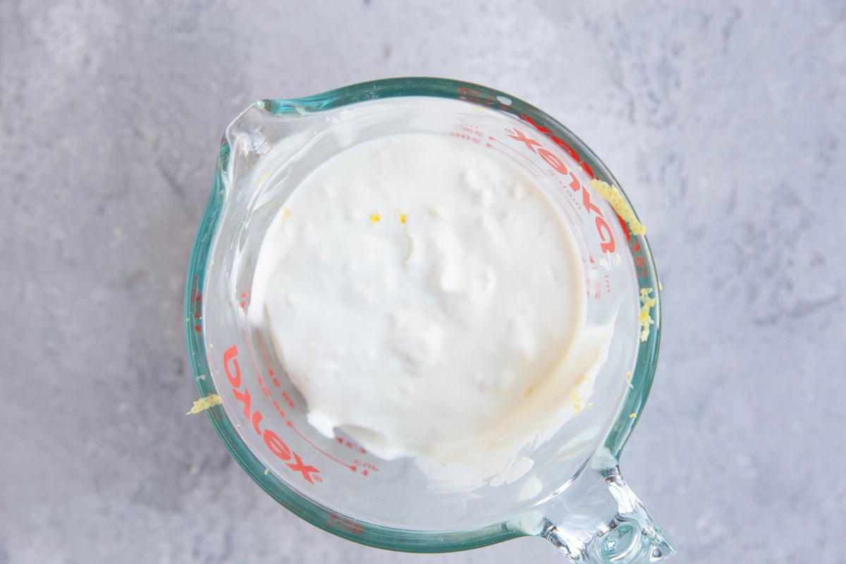 Ingredients for chicken salad dressing in a measuring cup.