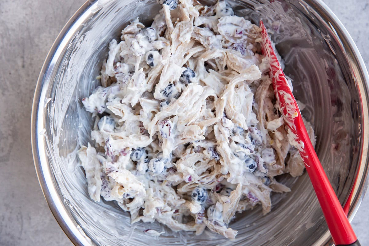 large mixing bowl full of pecan cranberry chicken salad, freshly made.