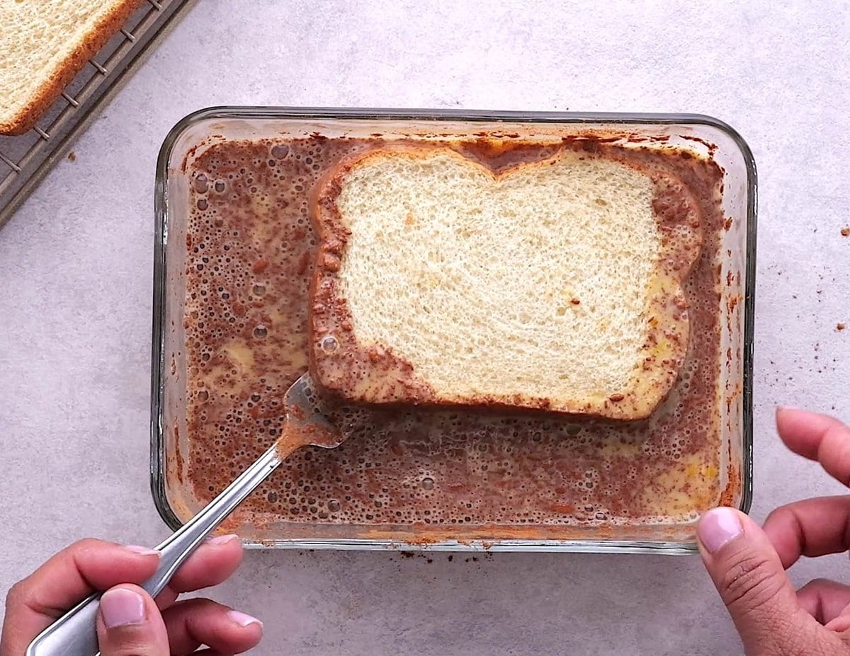Soaking bread in the custard mixture.