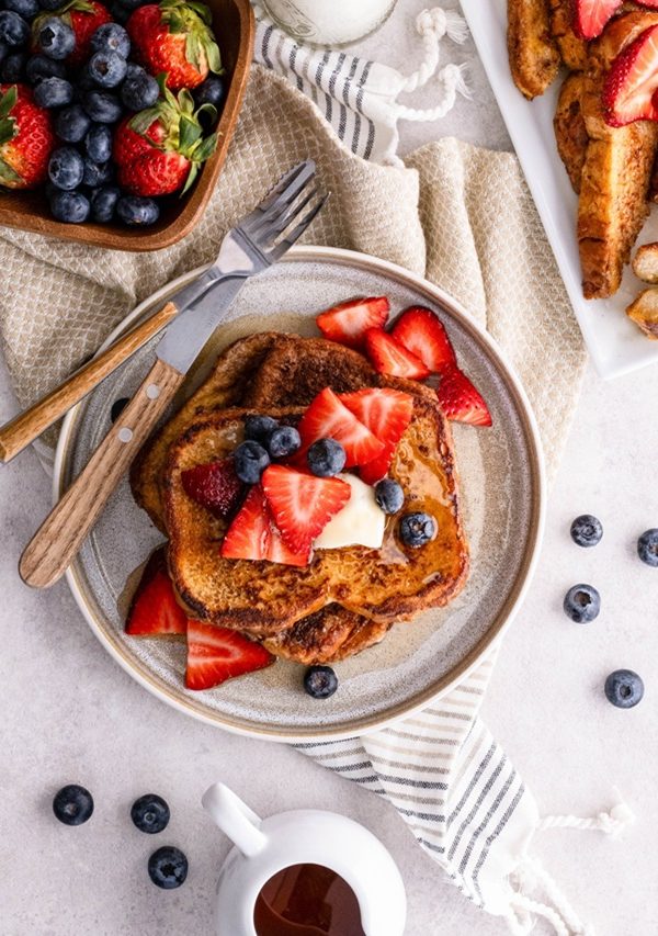Plate of French toast with berries on top