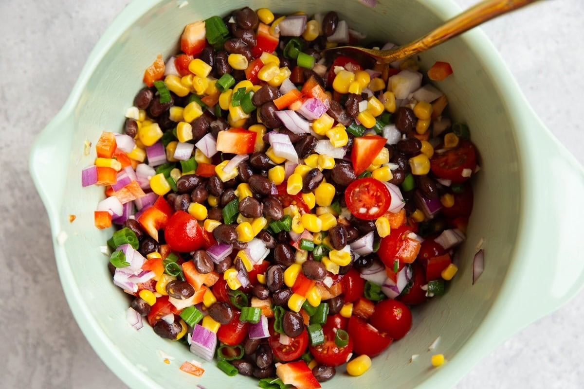 Large bowl full of black bean and corn salad.