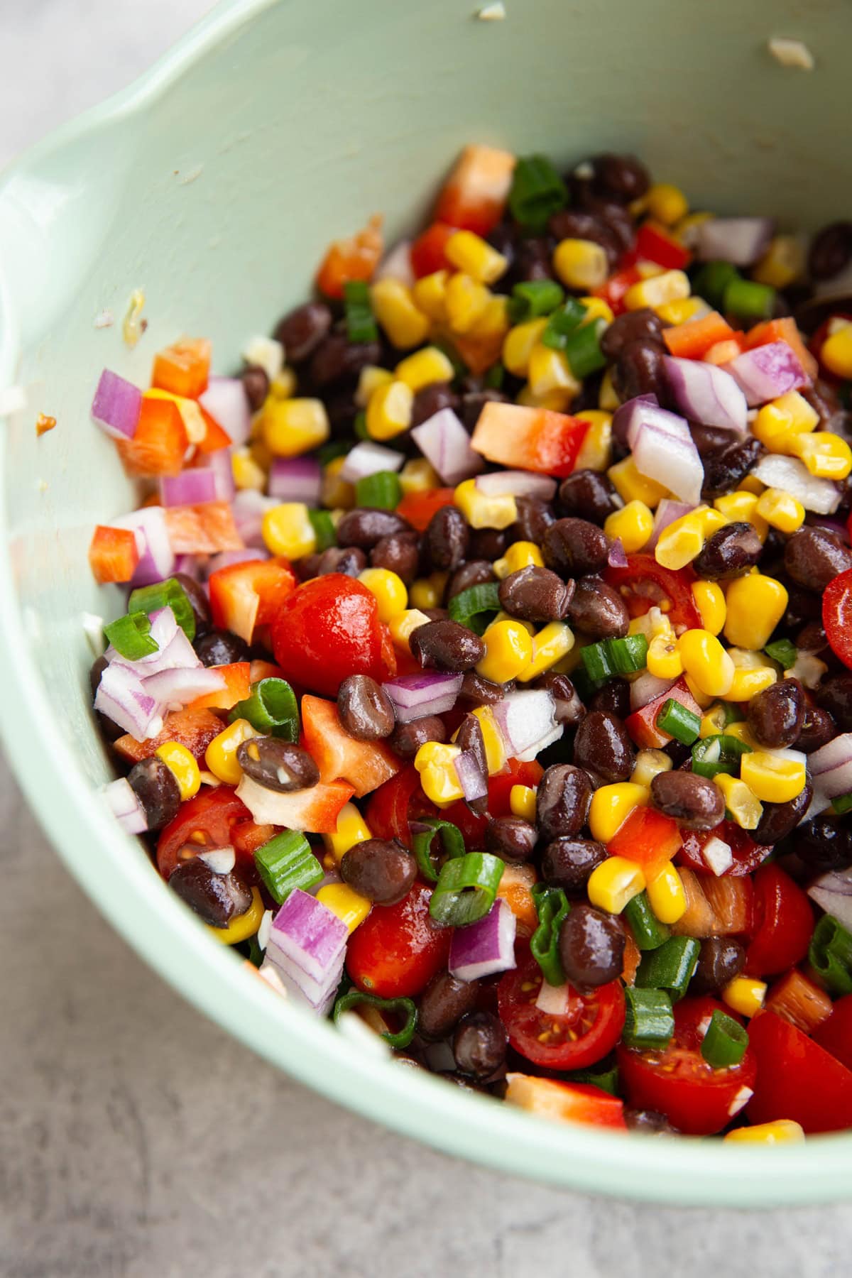 Mixing bowl full of black bean and corn salad.