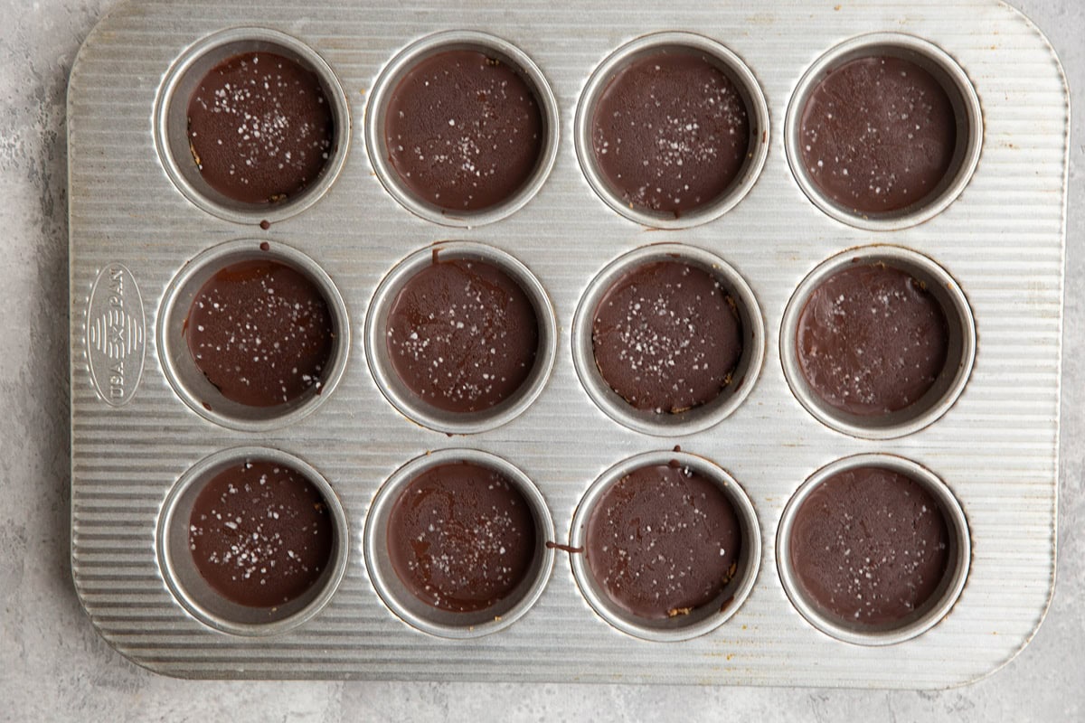 Muffin tin with chocolate covered protein energy bites inside, ready to serve.