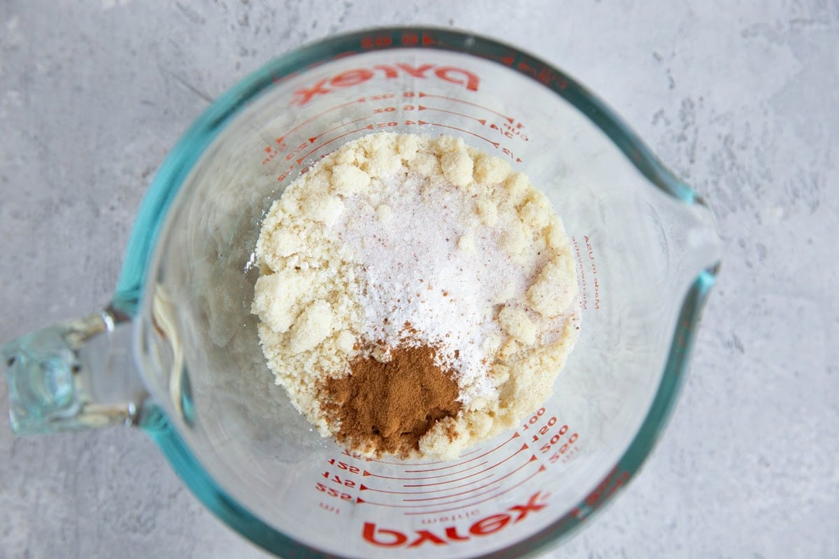 Measuring cup with almond flour, cinnamon, sea salt, and baking powder.