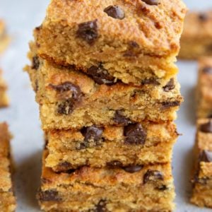 Stack of peanut butter bars with chocolate chips, exposing gooey centers.