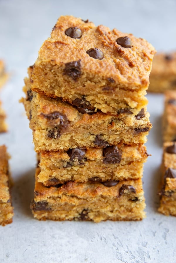 Stack of peanut butter bars with chocolate chips, exposing gooey centers.