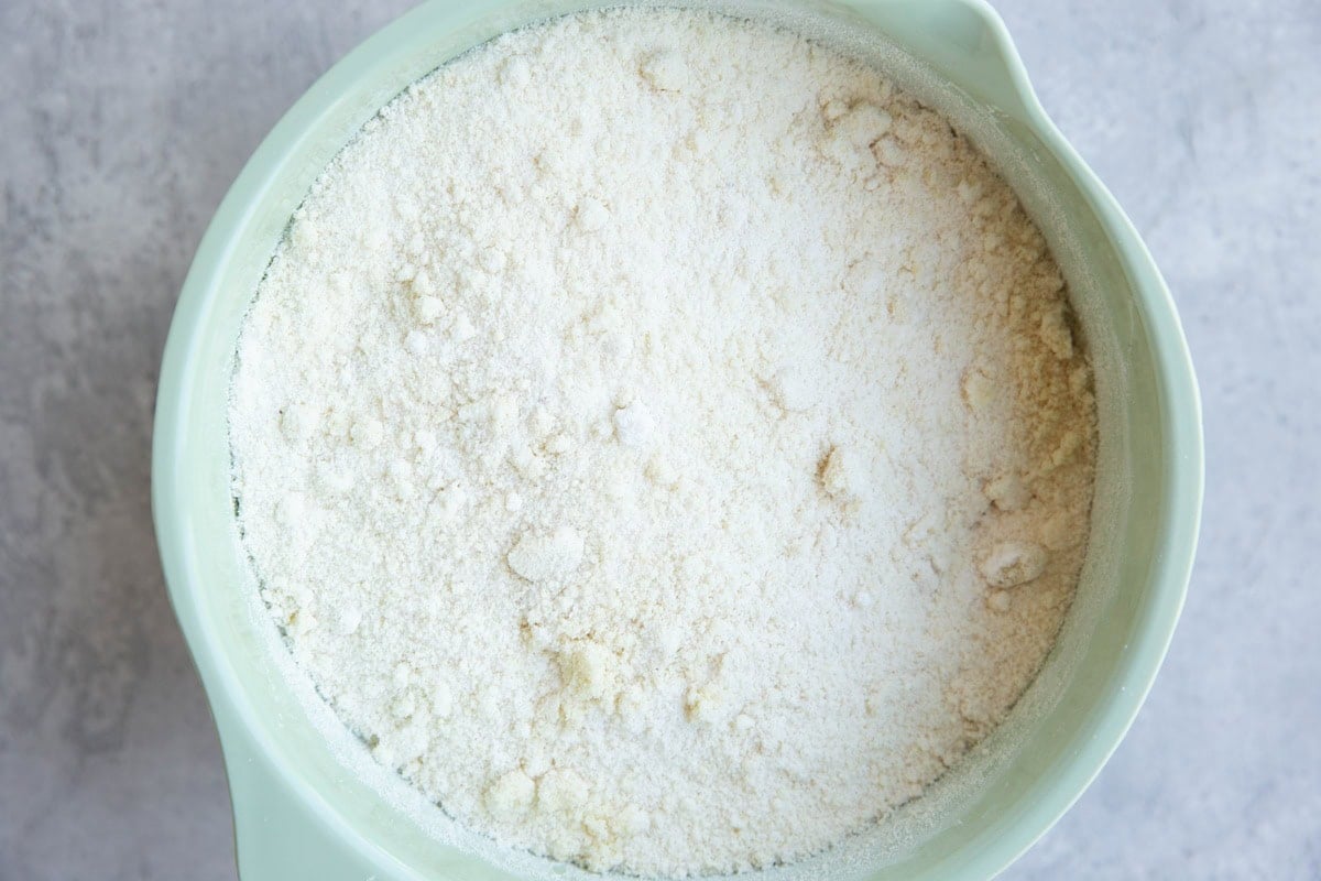 Mixing bowl full of dry ingredients to make cake.
