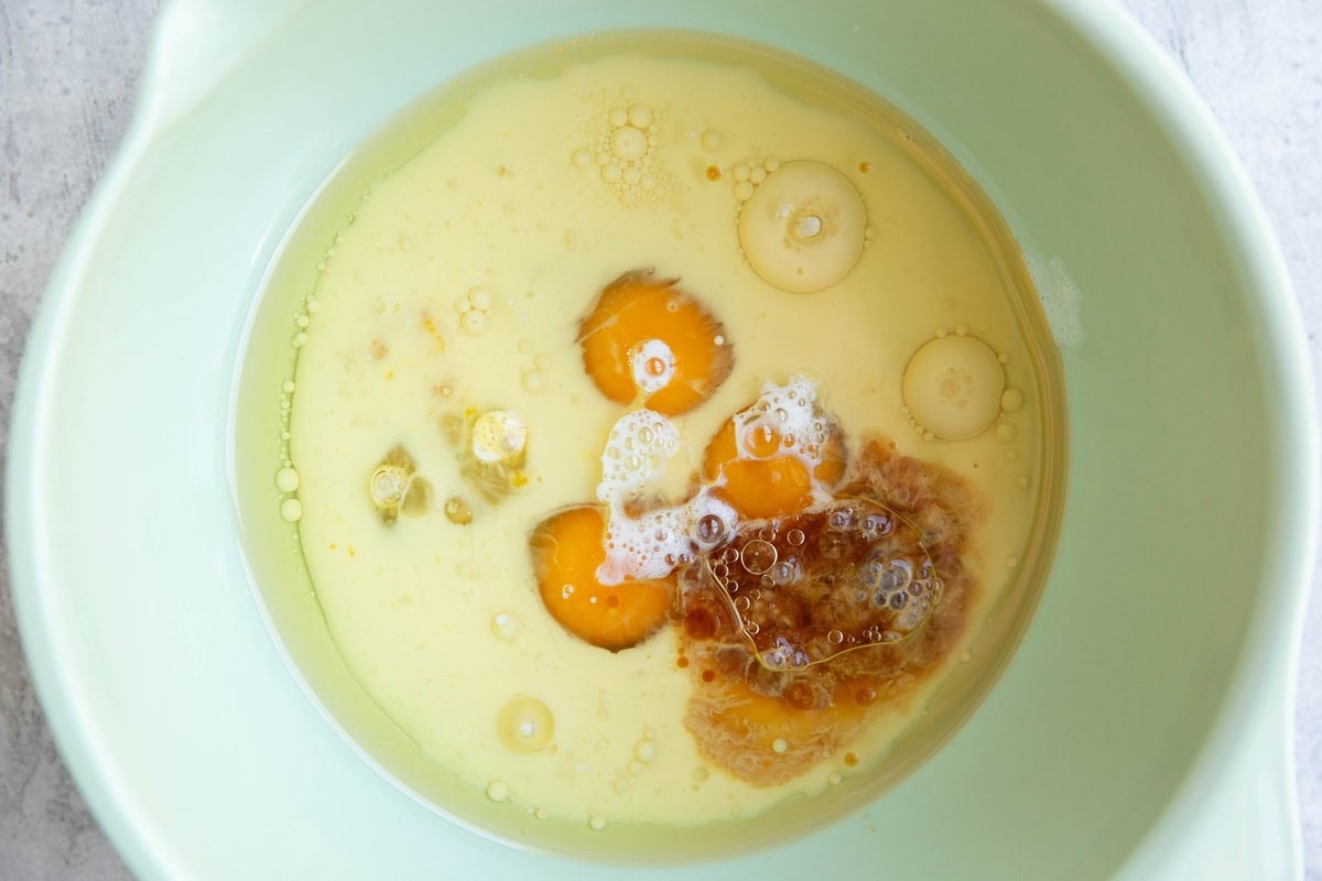 Wet ingredients for almond flour vanilla cake in a mixing bowl.
