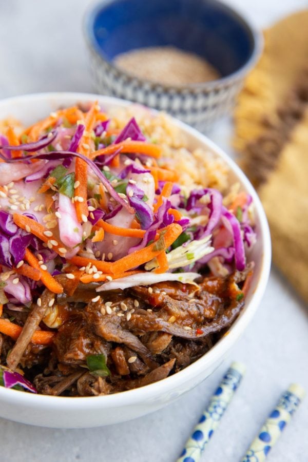 Shredded Korean beef bowls with coleslaw and brown rice.