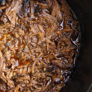 Shredded Korean BBQ beef in a slow cooker, ready to serve.