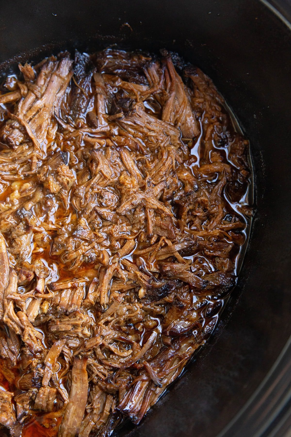 Shredded Korean BBQ beef in a slow cooker, ready to serve.