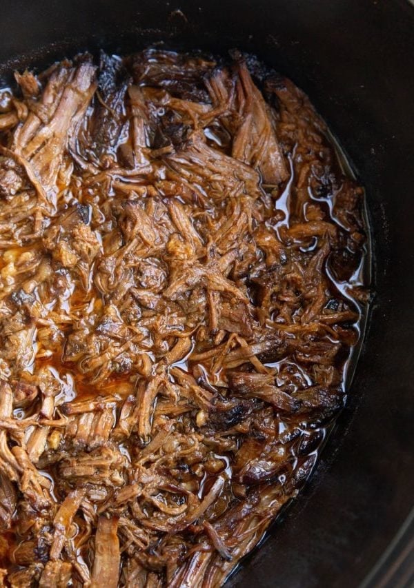 Shredded Korean BBQ beef in a slow cooker, ready to serve.