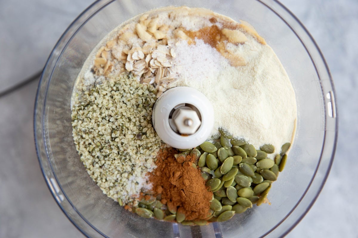 Ingredients for no-bake breakfast cookies in a food processor, ready to be blended together.