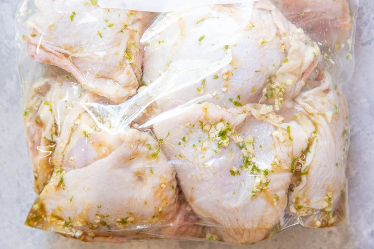 Zip lock bag full of chicken with marinade.