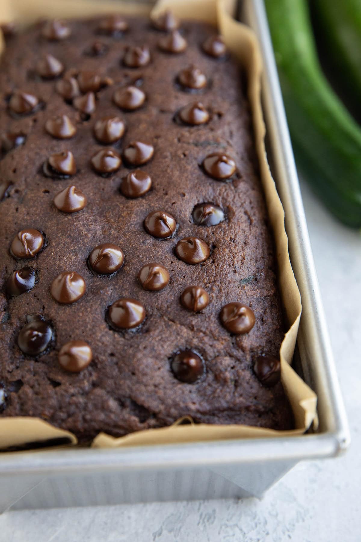 Loaf pan with chocolate zucchini bread inside, fresh out of the oven.