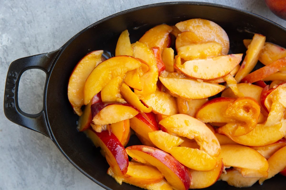 Baking dish with peach slices.