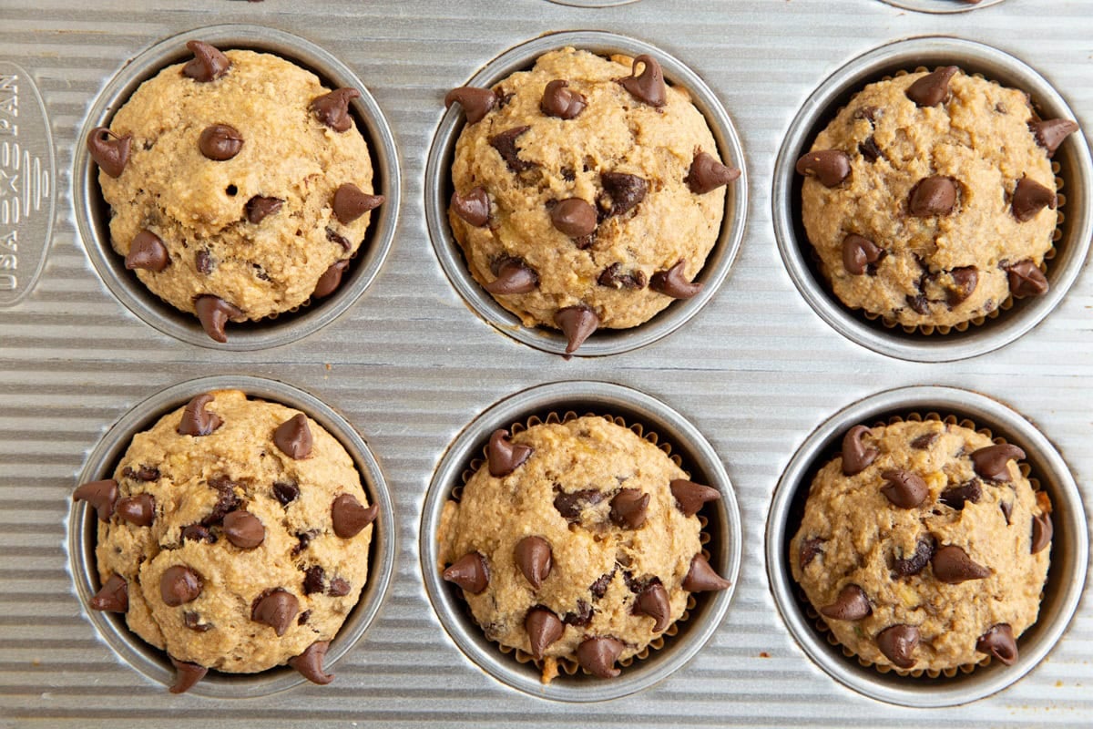 Muffin pan with baked oatmeal banana muffins inside, ready to eat.