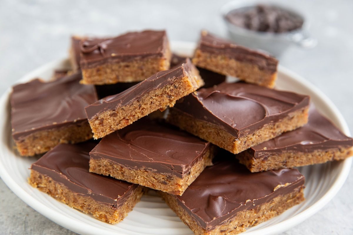 Slices of cookie dough protein bars on a plate.