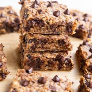 Stack of oatmeal protein bars with many bars all around.