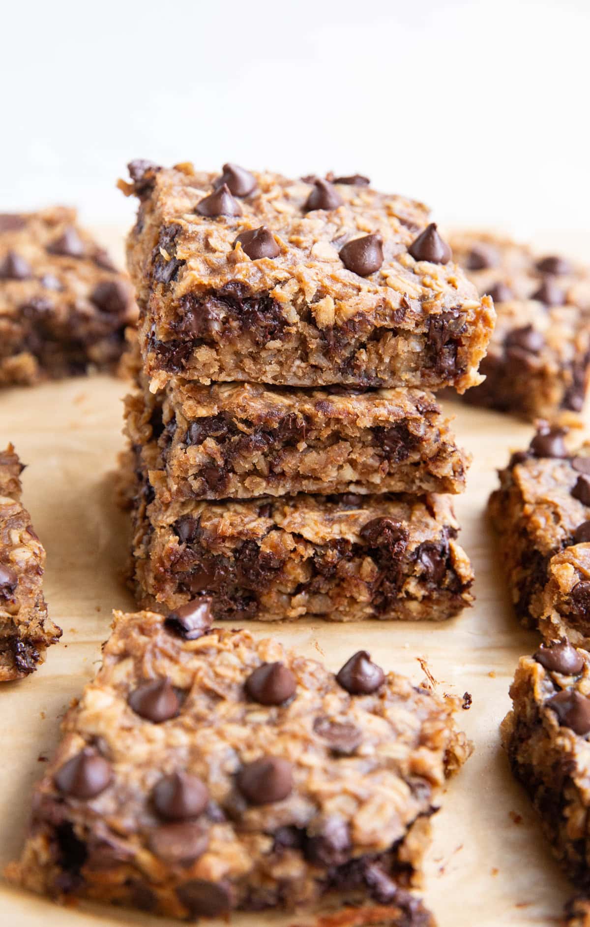 Stack of oatmeal protein bars with many bars all around.
