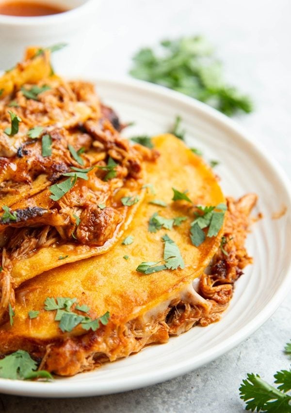 Four birria tacos on a plate