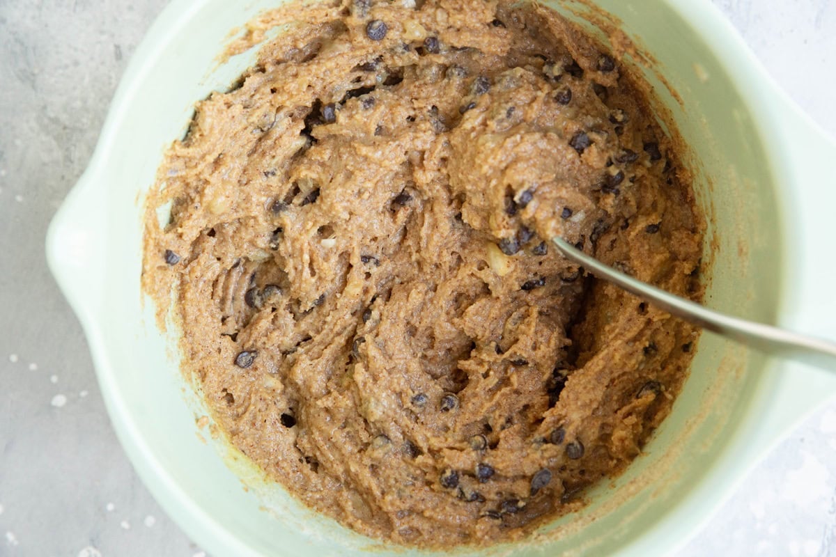 Mixing bowl full of peanut butter banana almond flour bars with chocolate chips.