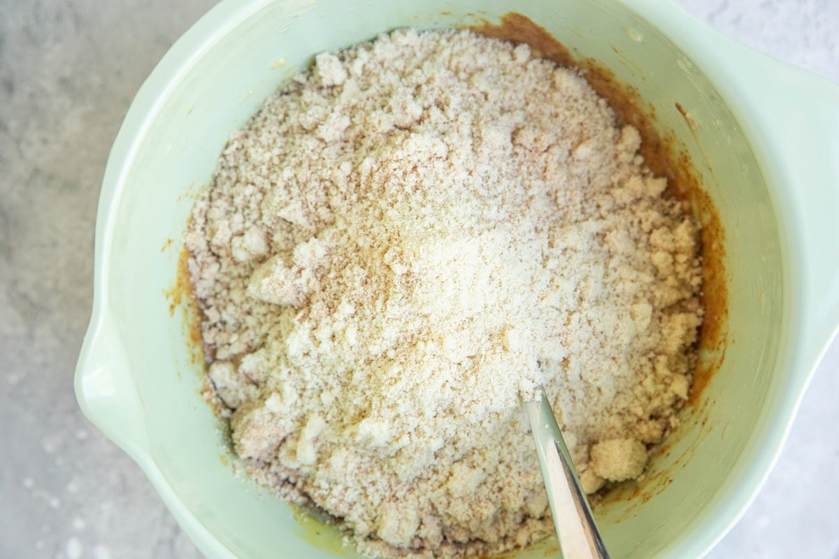 Mixing bowl with wet ingredients on the bottom and dry ingredients on the top to be mixed together.