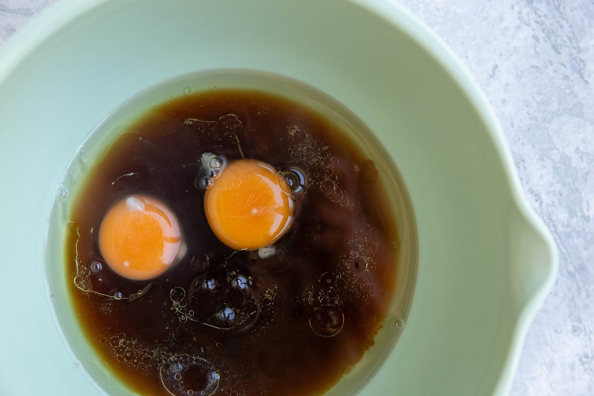 Mixing bowl with pure maple syrup, oil, and eggs.