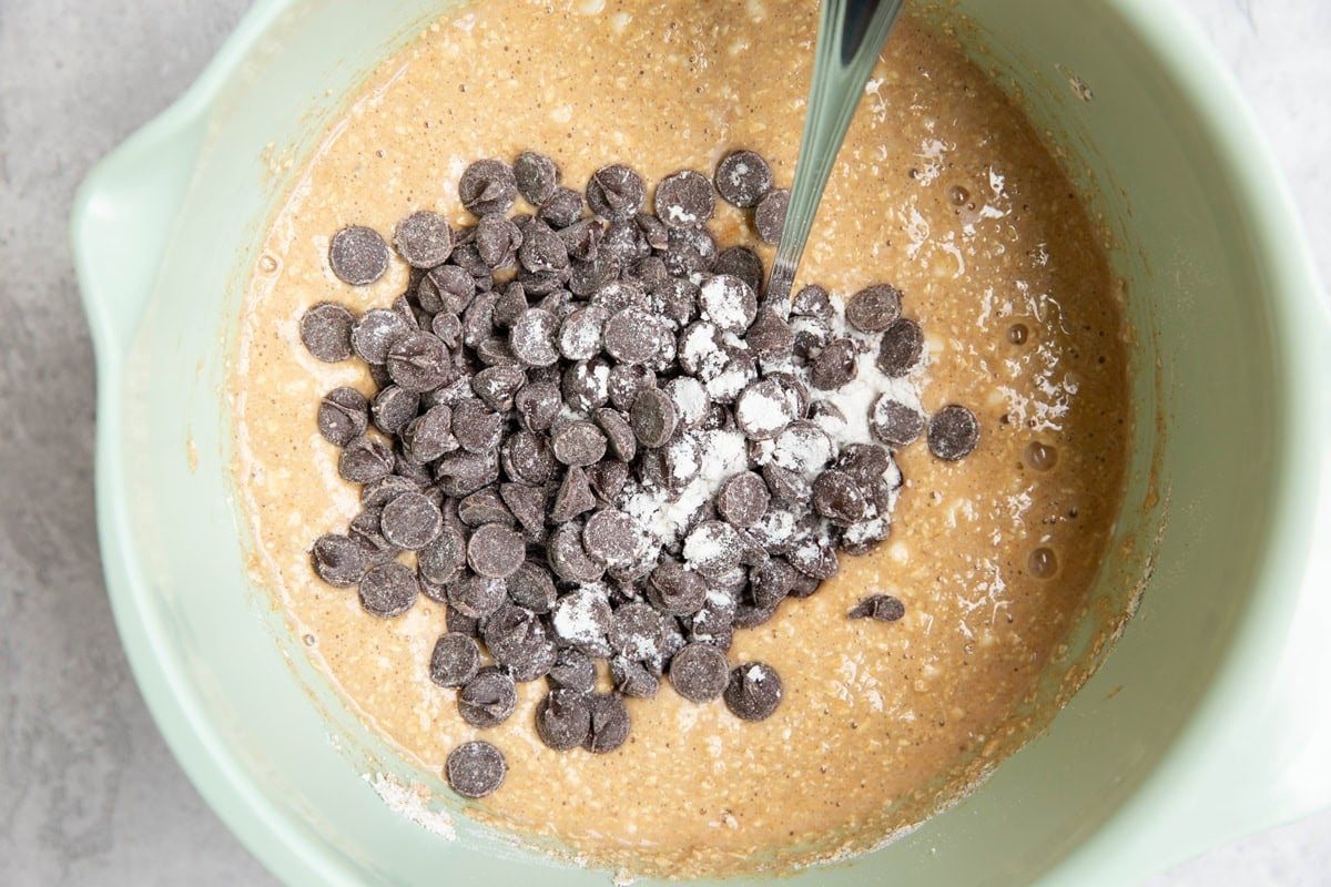 Oatmeal quick bread batter in a mixing bowl with chocolate chips sprinkled on top.