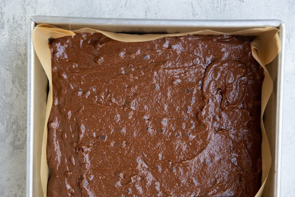 Baking dish full of brownie batter, ready to go into the oven.