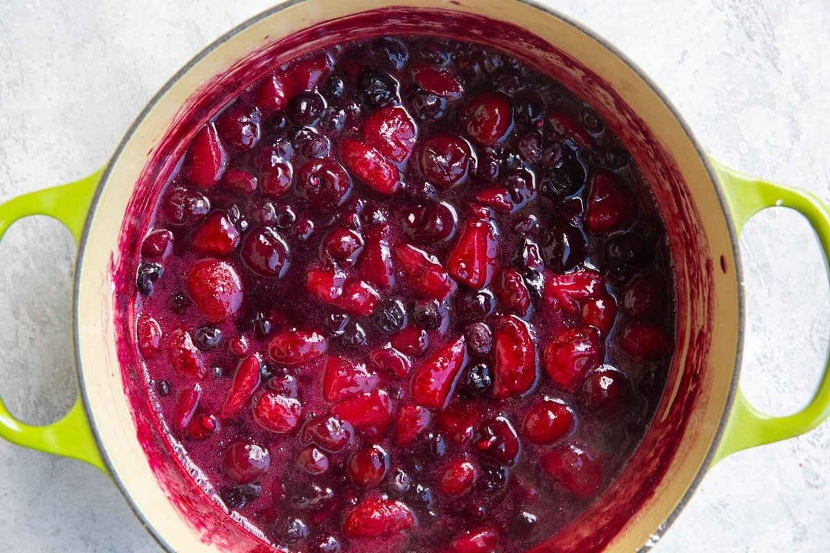 Pot full of stewed berries to make berry cobbler.