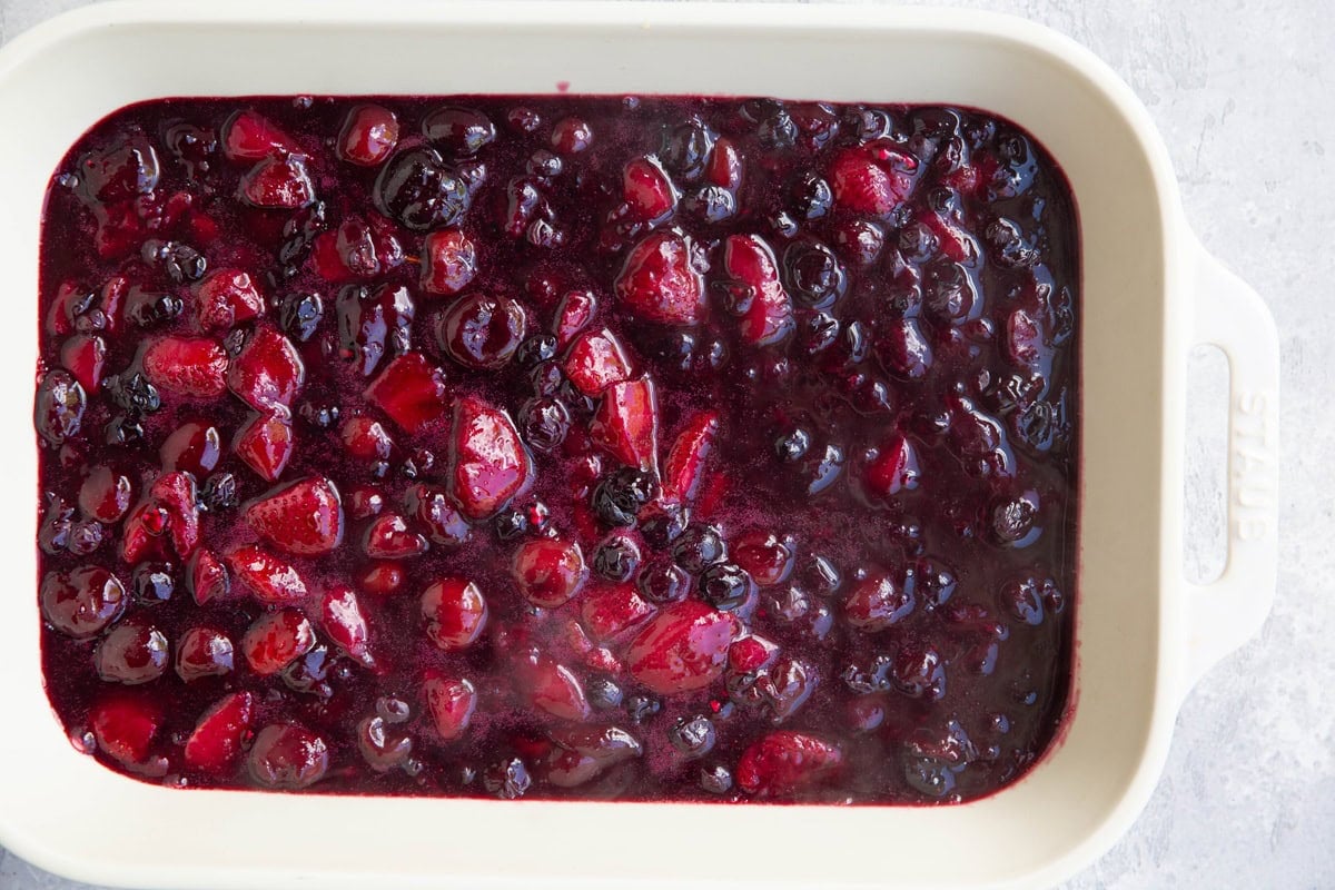 large casserole dish full of mixed berry filling.