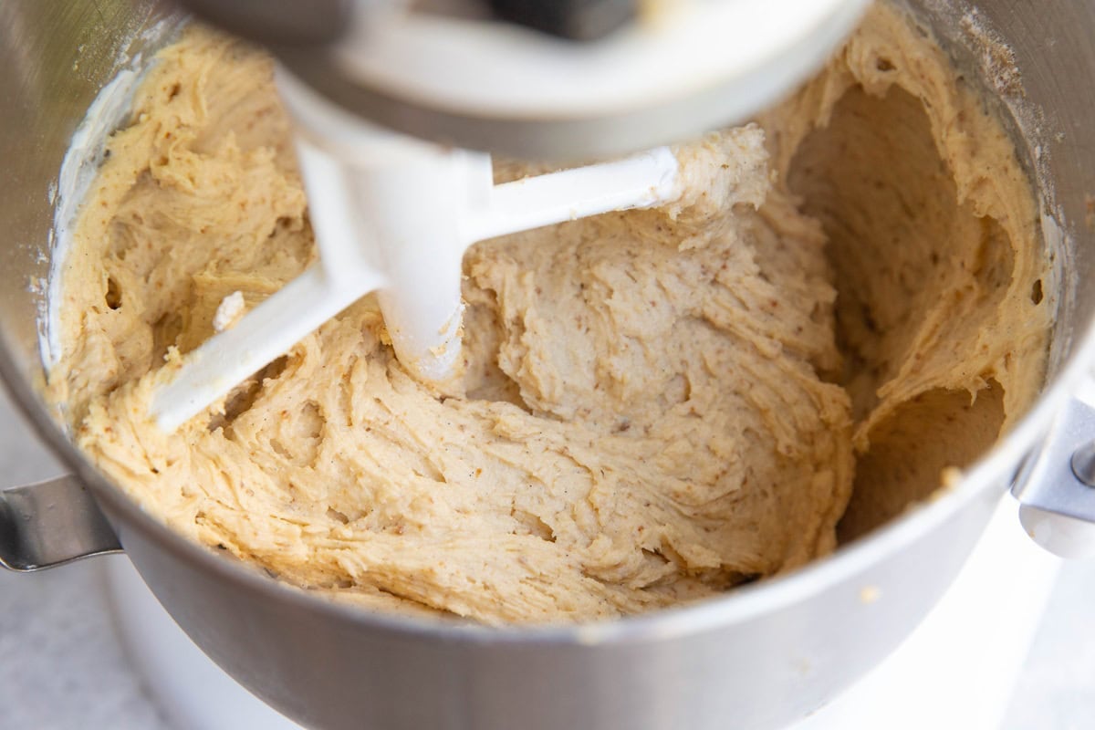 Vanilla cake batter in a stand mixer with a paddle attachment, finished preparing the batter and ready to use.