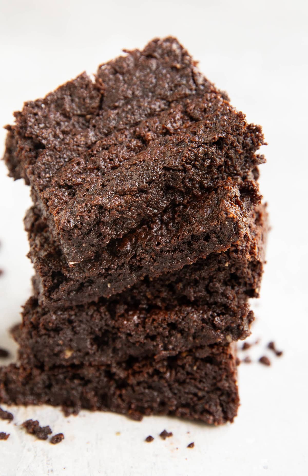 Stack of five oat flour brownies on top of one another.