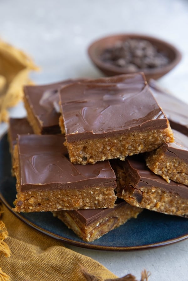 Plate of protein bars with a bowl of chocolate chips in the background.