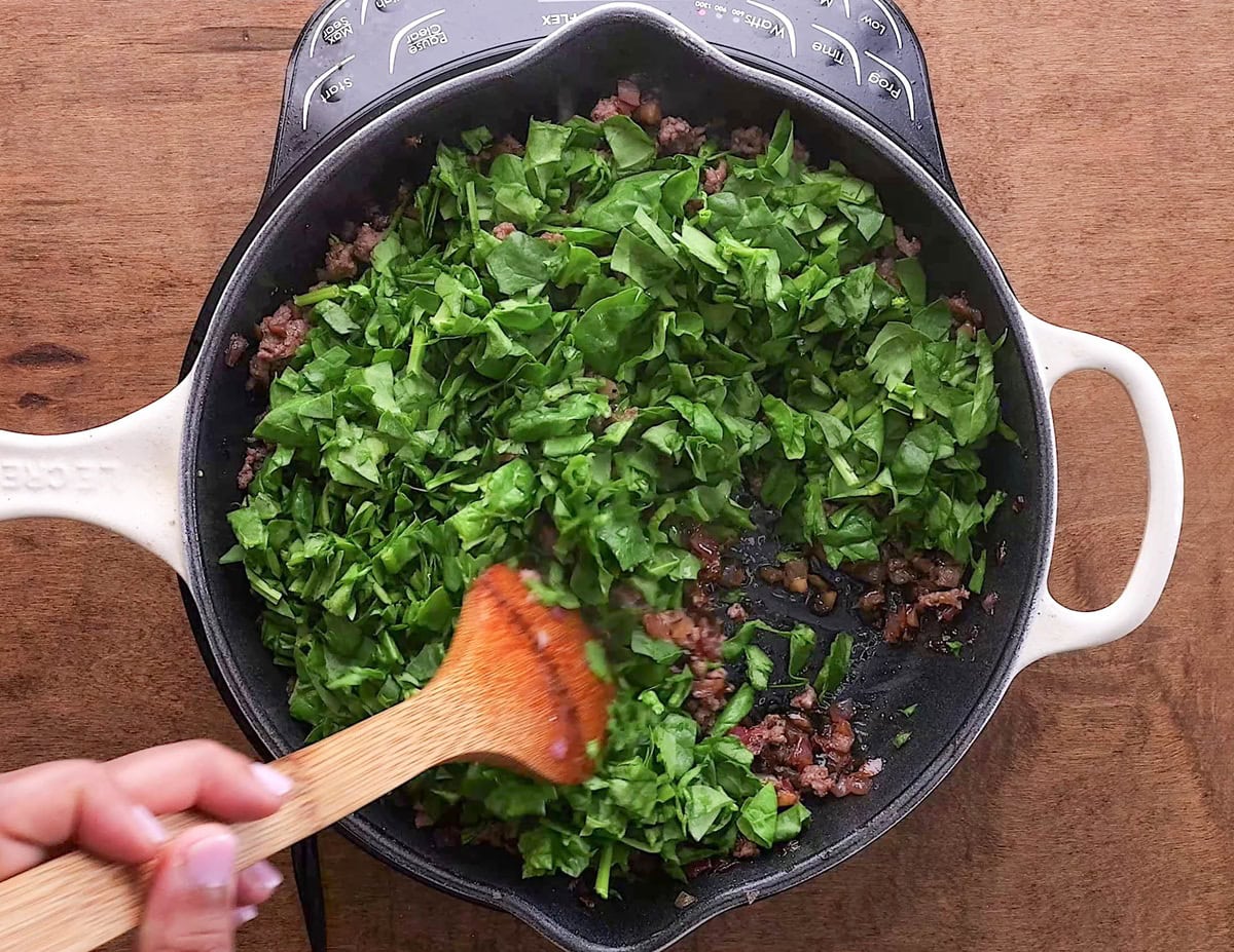 Spinach on top of meat mixture.