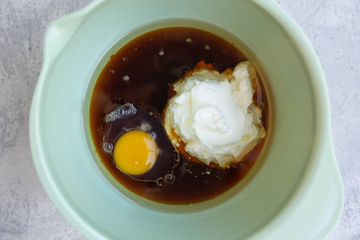 Greek yogurt, pure maple syrup, avocado oil, and egg in a large mixing bowl to mix.