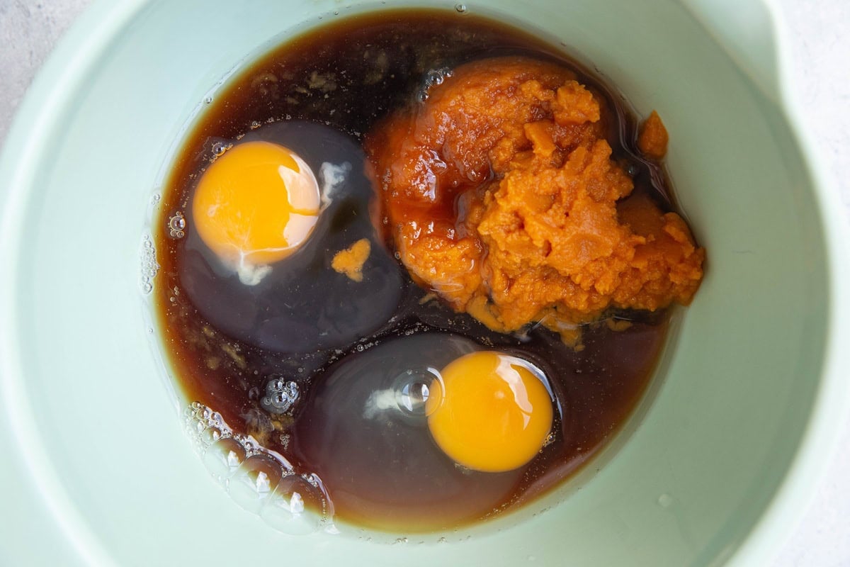 pumpkin puree, pure maple syrup, and eggs in a mixing bowl