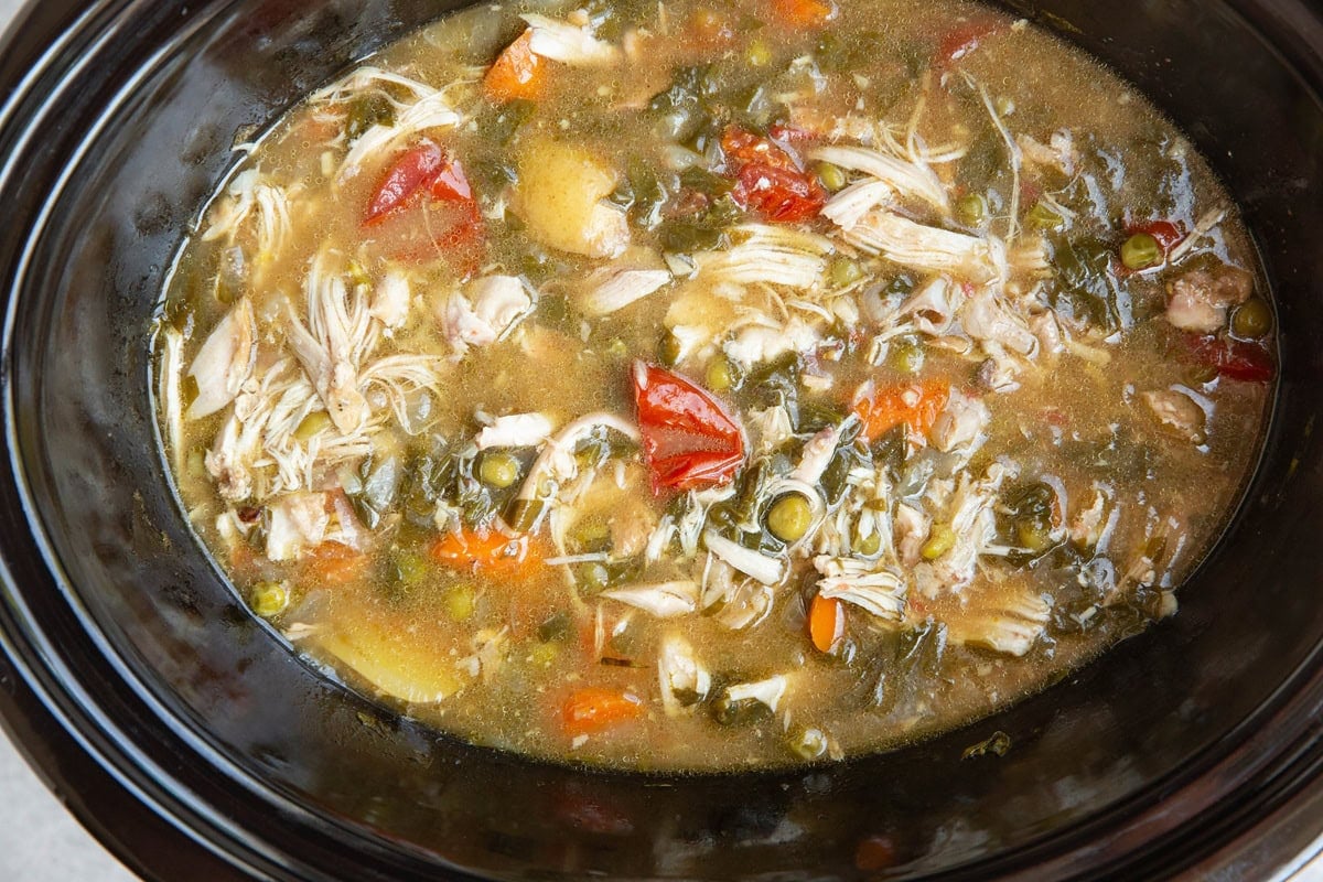 Slow cooker full of chicken stew, ready to serve.